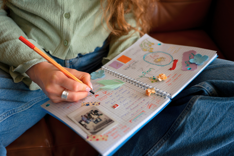 front view woman doing creative journaling