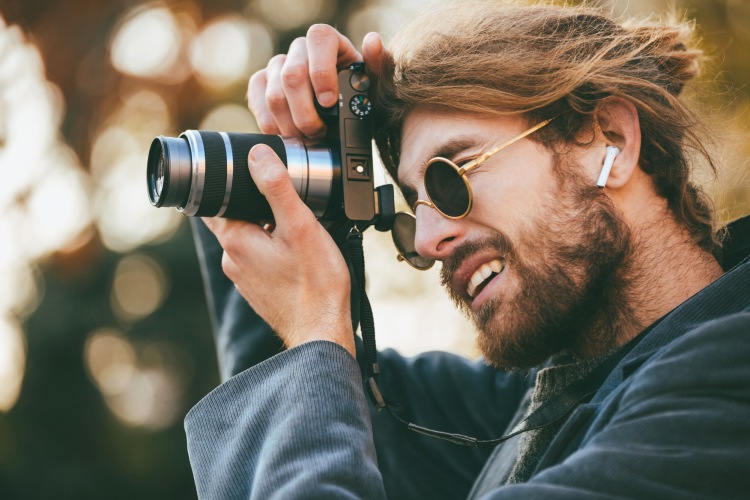 bearded man taking photo