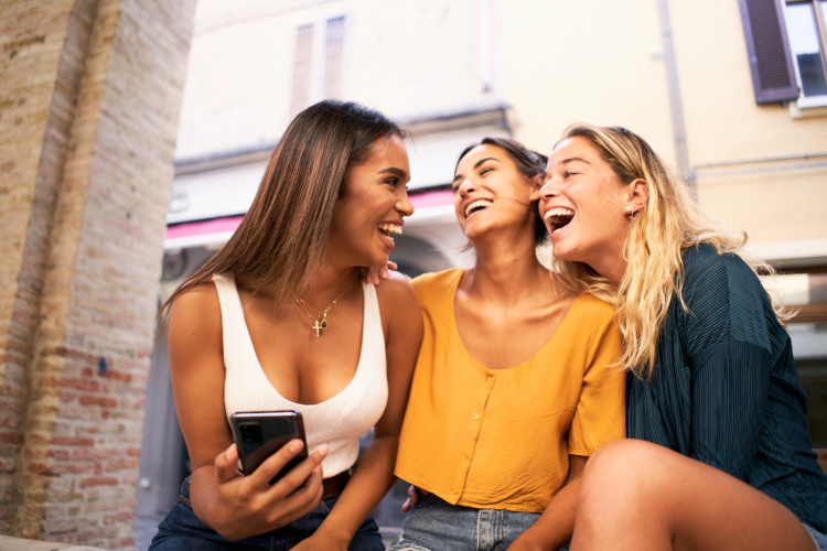 three multiracial women laughing