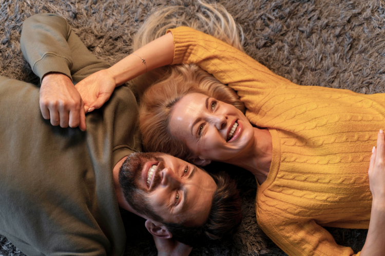 happy couple smiling and lying down