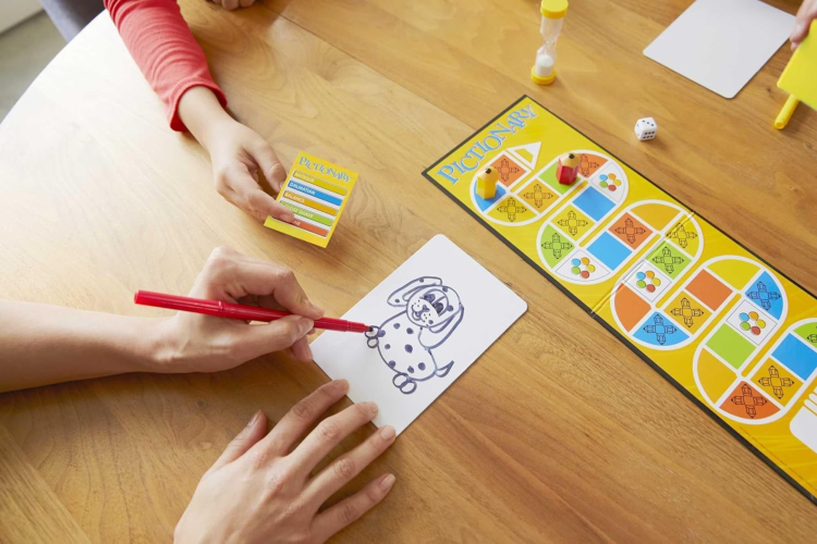 Family playing pictionary board game