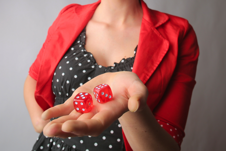 woman holding a pair of die