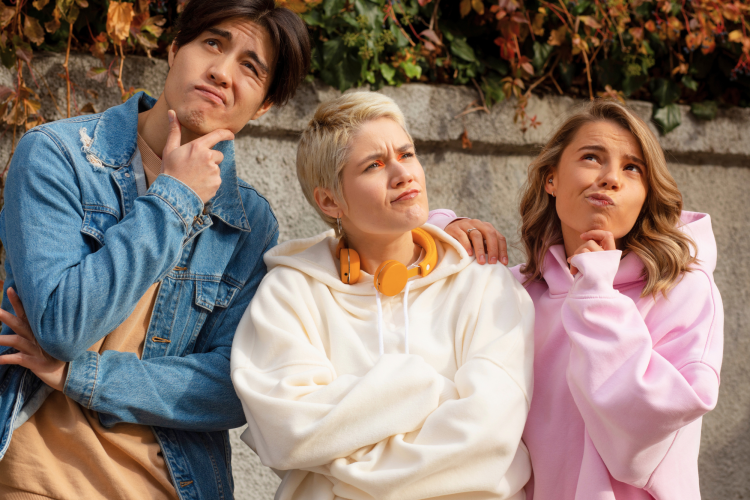 Group of friends thinking about Medium Difficulty Scavenger Hunt Clues