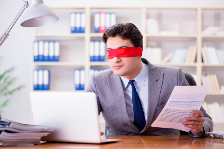 man with a blindfold typing in the office
