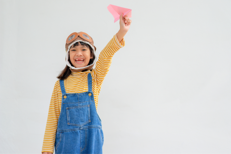 girl flying a paper plane