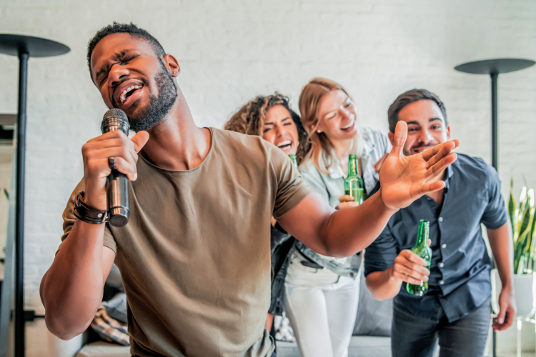 diverse group of friends singing karaoke