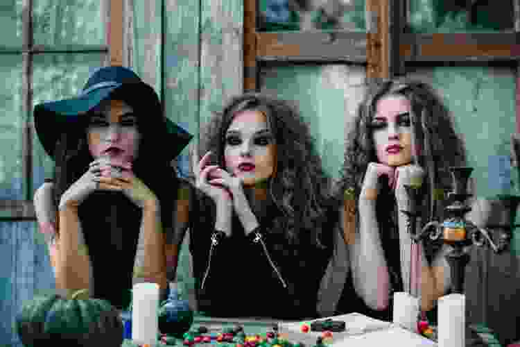 Women in witch costumes for halloween party theme