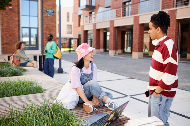 two students chatting outside a university