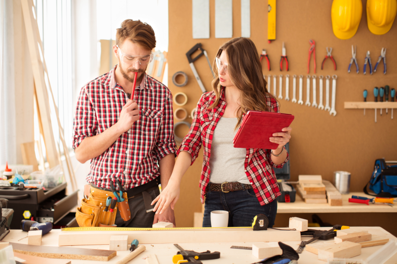 man and woman working together in woodshop