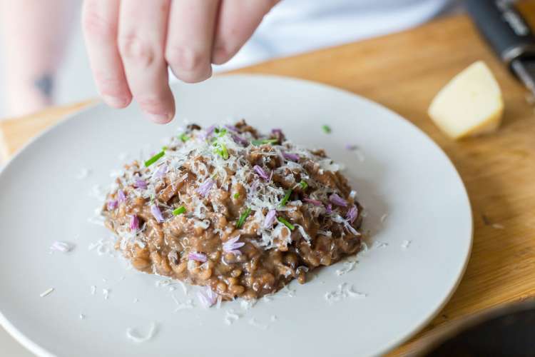 private chef on cozymeal plating risotto