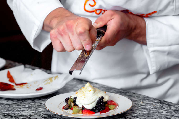 a chef garnishing a meringue