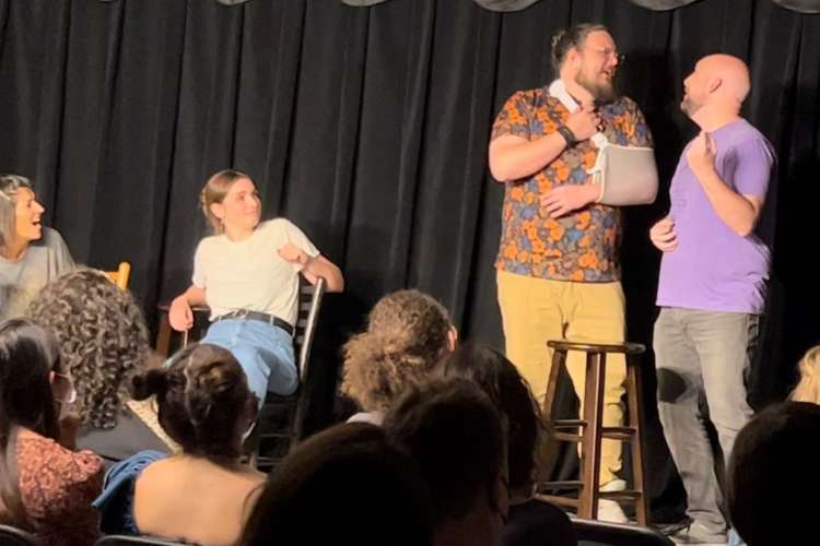 a group of people doing an improv act on a stage