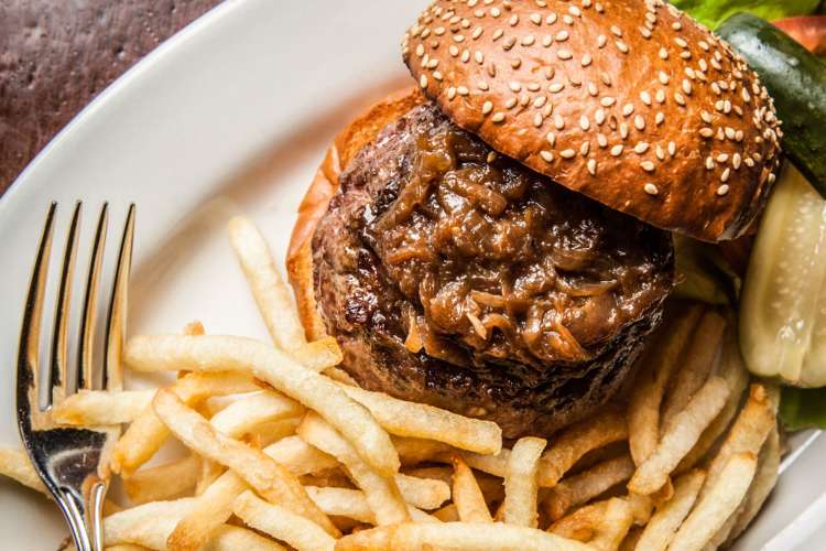 a hamburger with caramelized onions