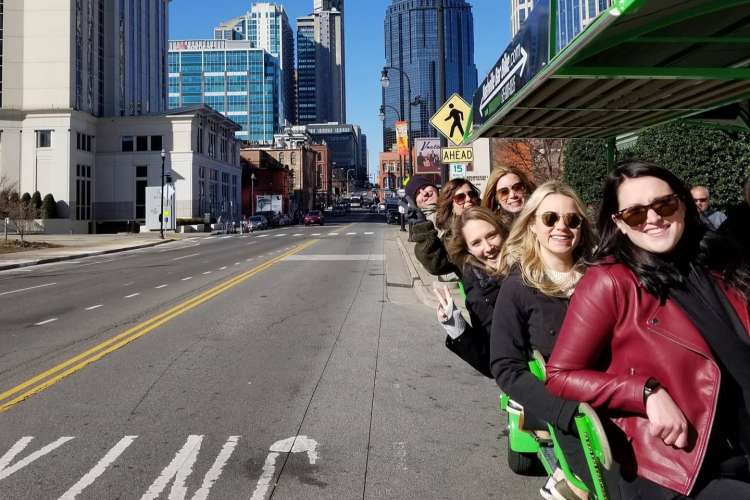 friends enjoying drinks on the nashville bar bike while pedaling downtown