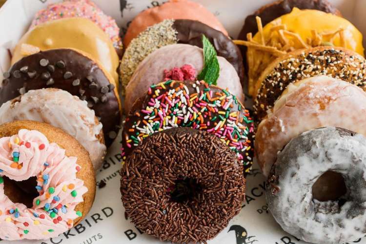 a box of various colorful donuts