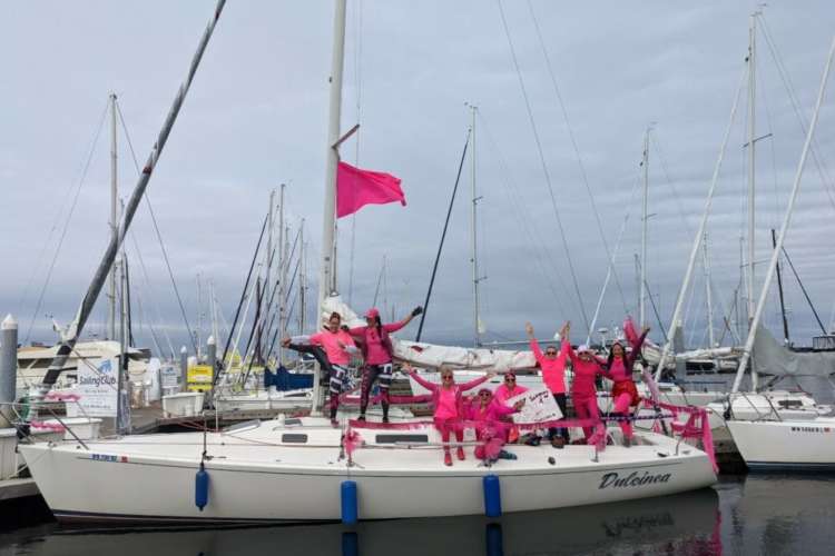 a pink-flagged sailboat in honor of breast cancer research