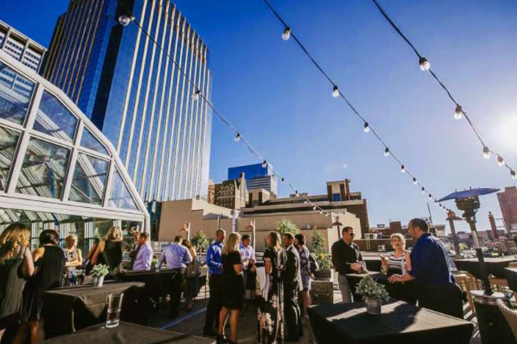 a large group of professionals having a corporate team building activity on Union Rooftop