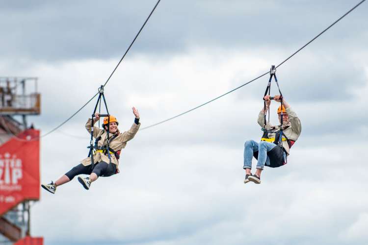 two people zip lining high in the air in Ottawa