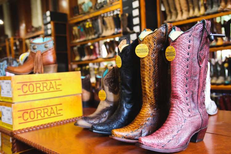 women's cowboy boots lined up for sale and wild bill's western store in dallas