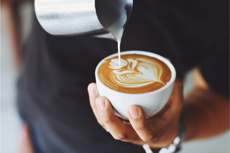 barista making a latte