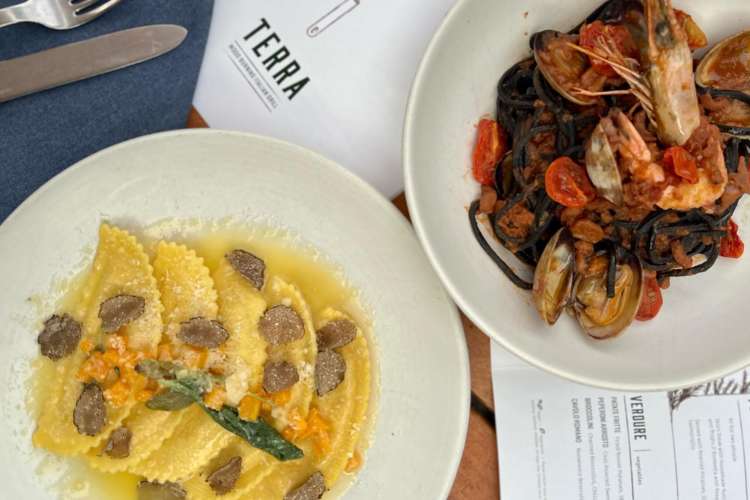 butternut squash ravioli and a plate of shellfish in red sauce