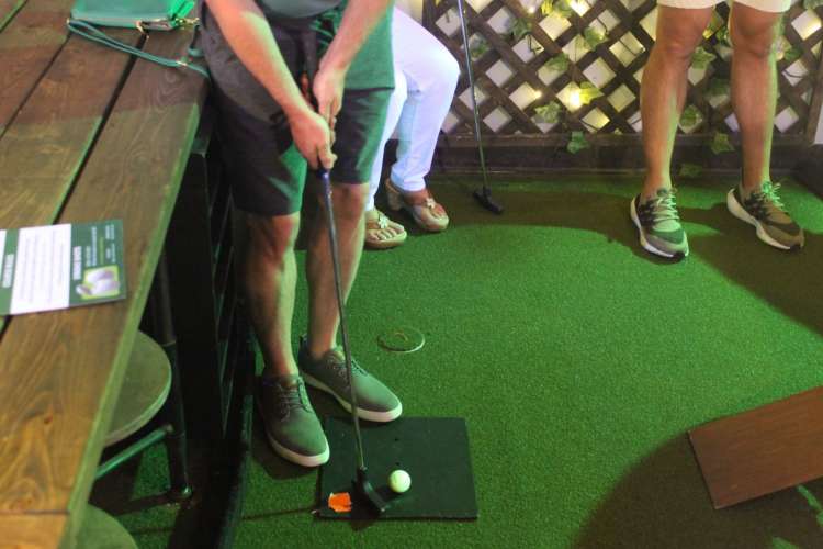 A man prepares to hit a golf ball. 