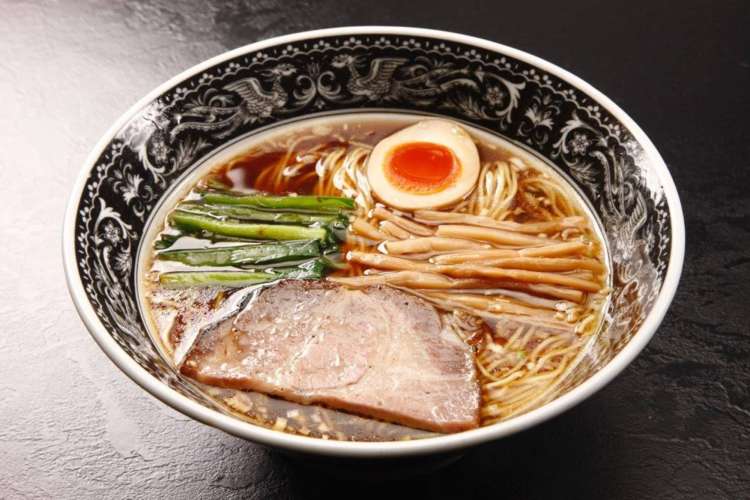 a bowl of clear broth ramen