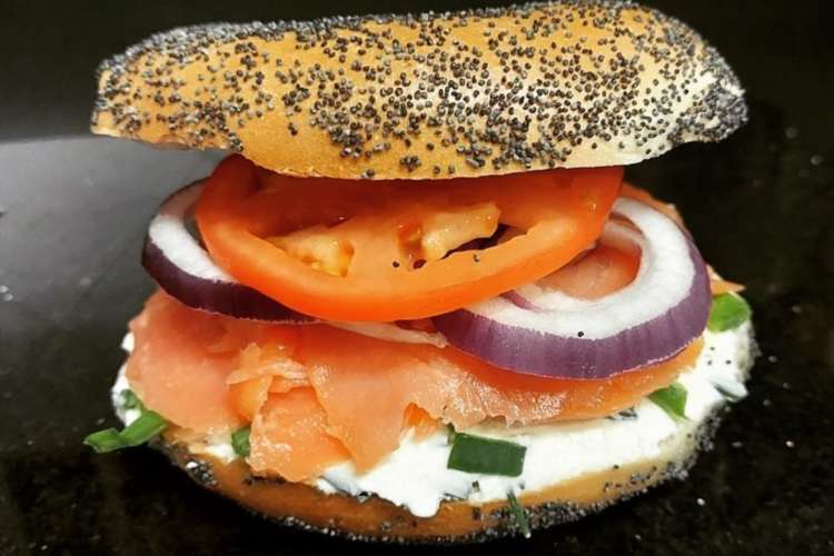 bagel sandwich with smoked salmon, onions, and tomato