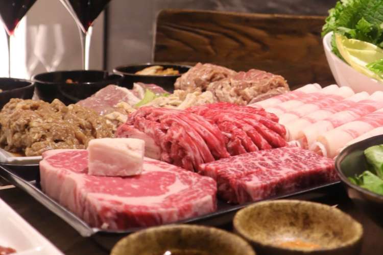 a combination of various uncooked meats at a Korean barbecue