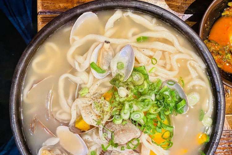 a bowl of white clam noodles