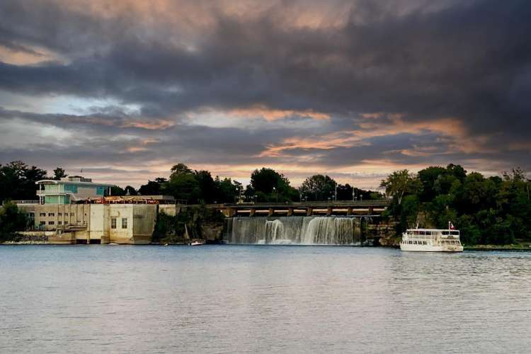 a boat cruises in the water near Rideau Falls