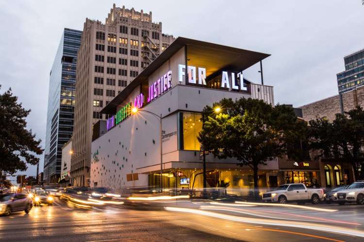 exterior of the contemporary museum in austin lit up in the evening