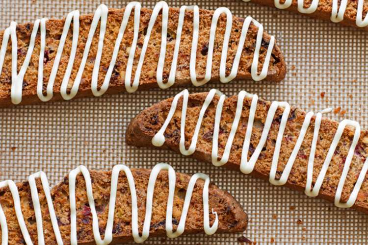 these crisp cranberry pistachio biscotti with white chocolate drizzle pairs perfectly with a cup of hot coffee or tea 