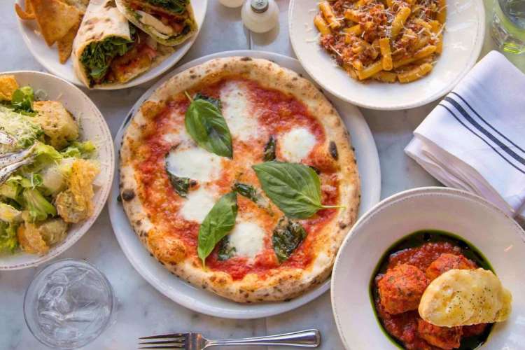 a table full of pizzas and pasta from Pastoral 