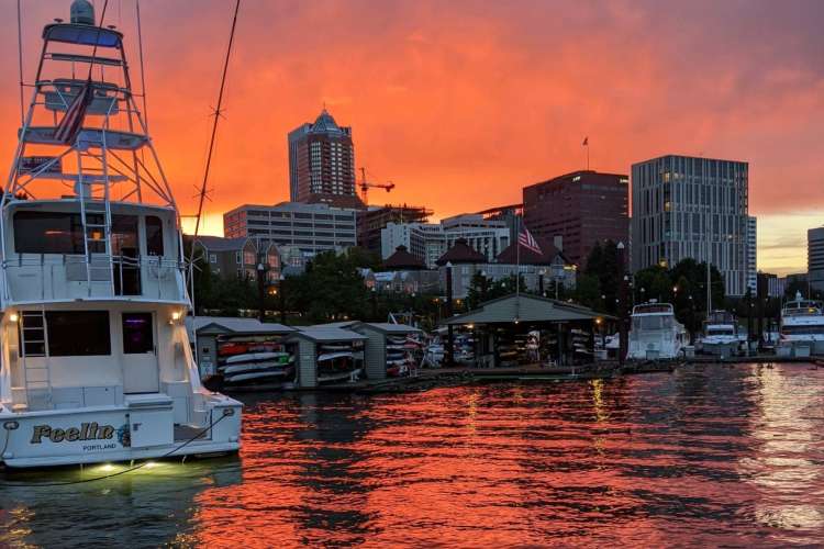 boats docked in Portland below a vivid rosy sunset