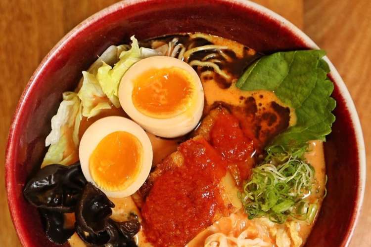 a bowl of ramen with spicy paste and an egg