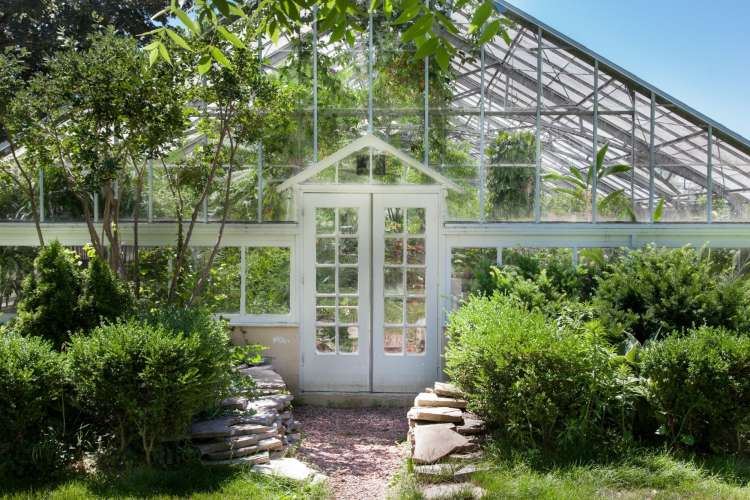 the door to a lush greenhouse in Allan Gardens