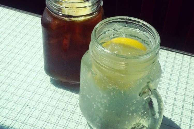 two drinks in Mason jars, one coffee-based, one soda water-based