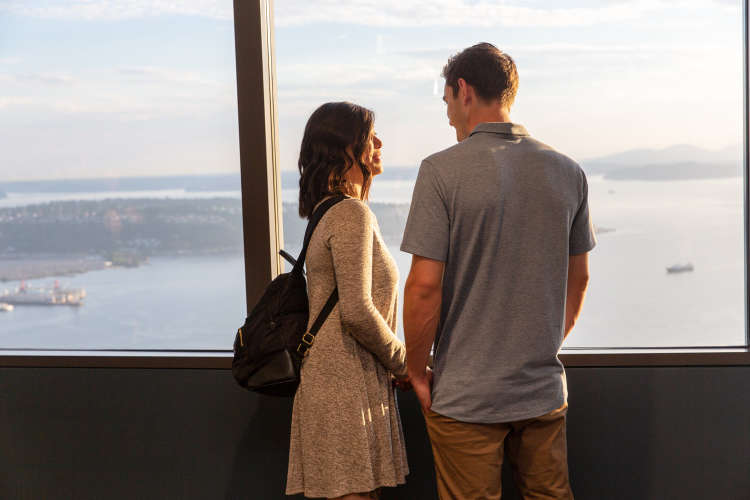 couple looking out over seattle from the sky view observatory