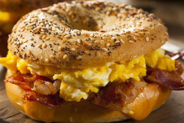 an egg, cheese, and bacon bagel sandwich