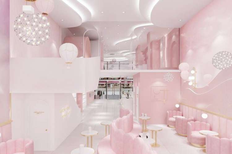 a pastel pink and white shop with chandeliers
