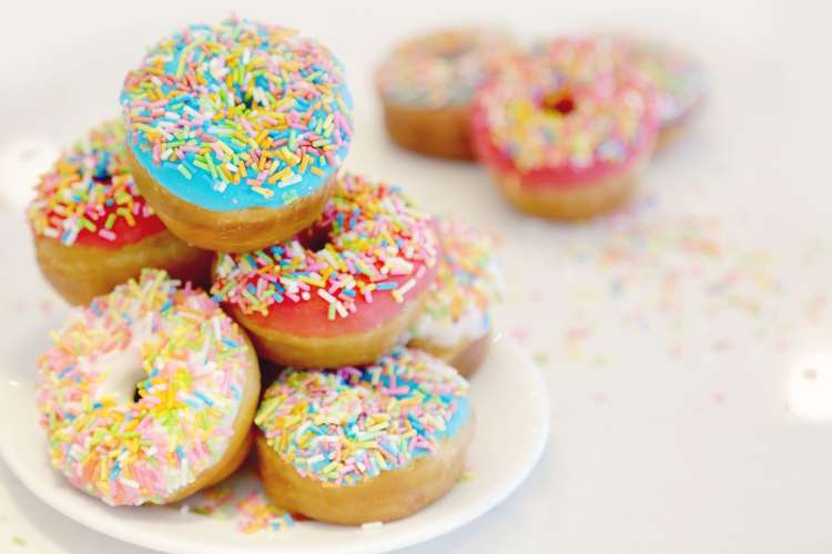 Decorating doughnuts is a fun office breakfast idea.