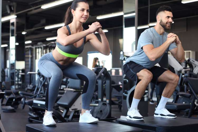 a man and woman work out together in a gym