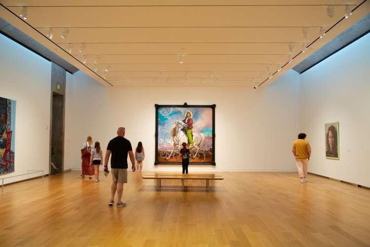 tourists admiring art in the modern art museum of fort worth