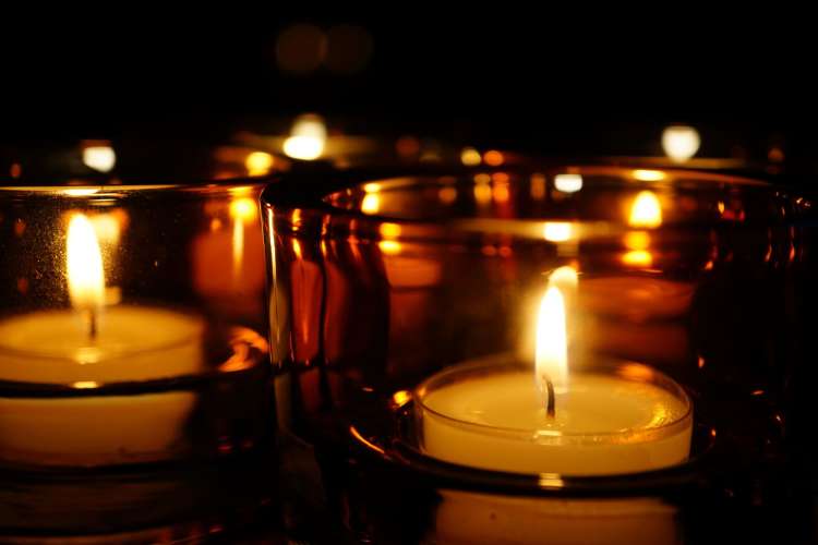 candles grouped together among a dark background