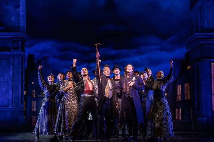 a troupe of actors onstage during a Les Miserables performance