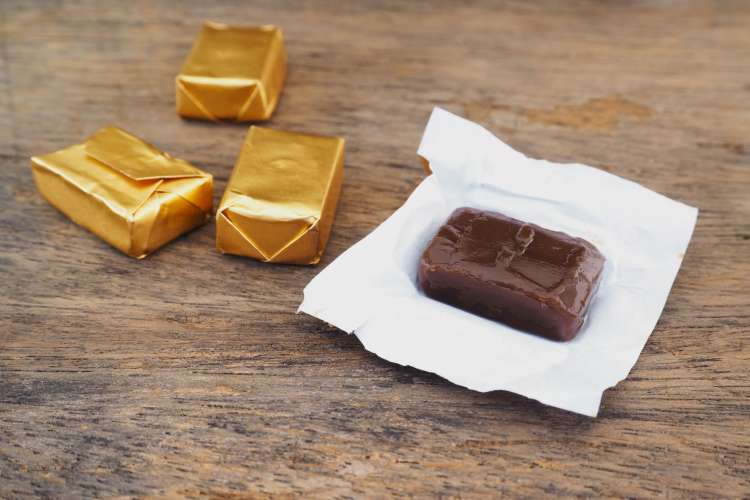 pieces of chocolate wrapped in gold foil on a table