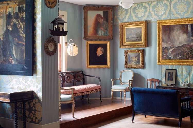 a room full of art paintings and antique furniture