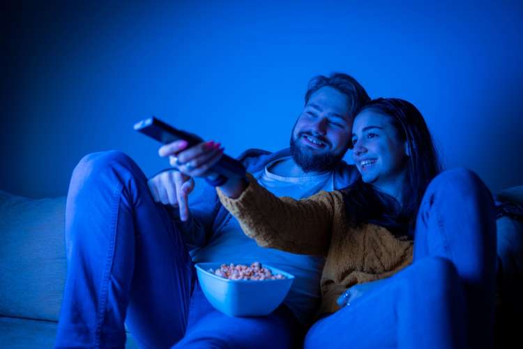 a couple watching a movie on the sofa