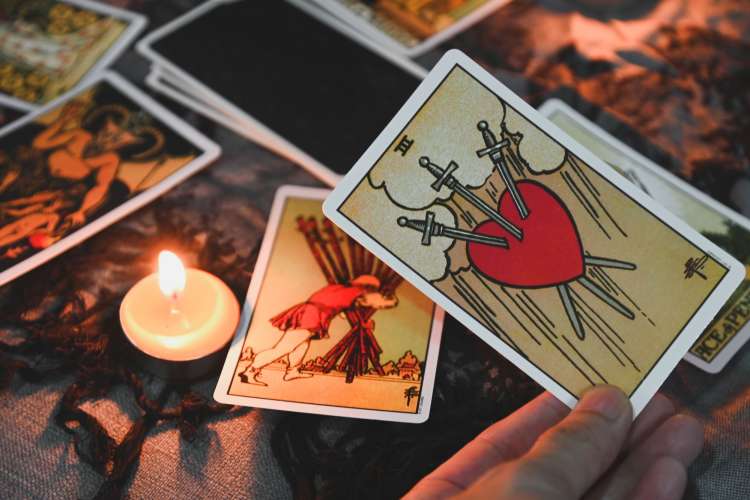 an assortment of tarot cards on a table